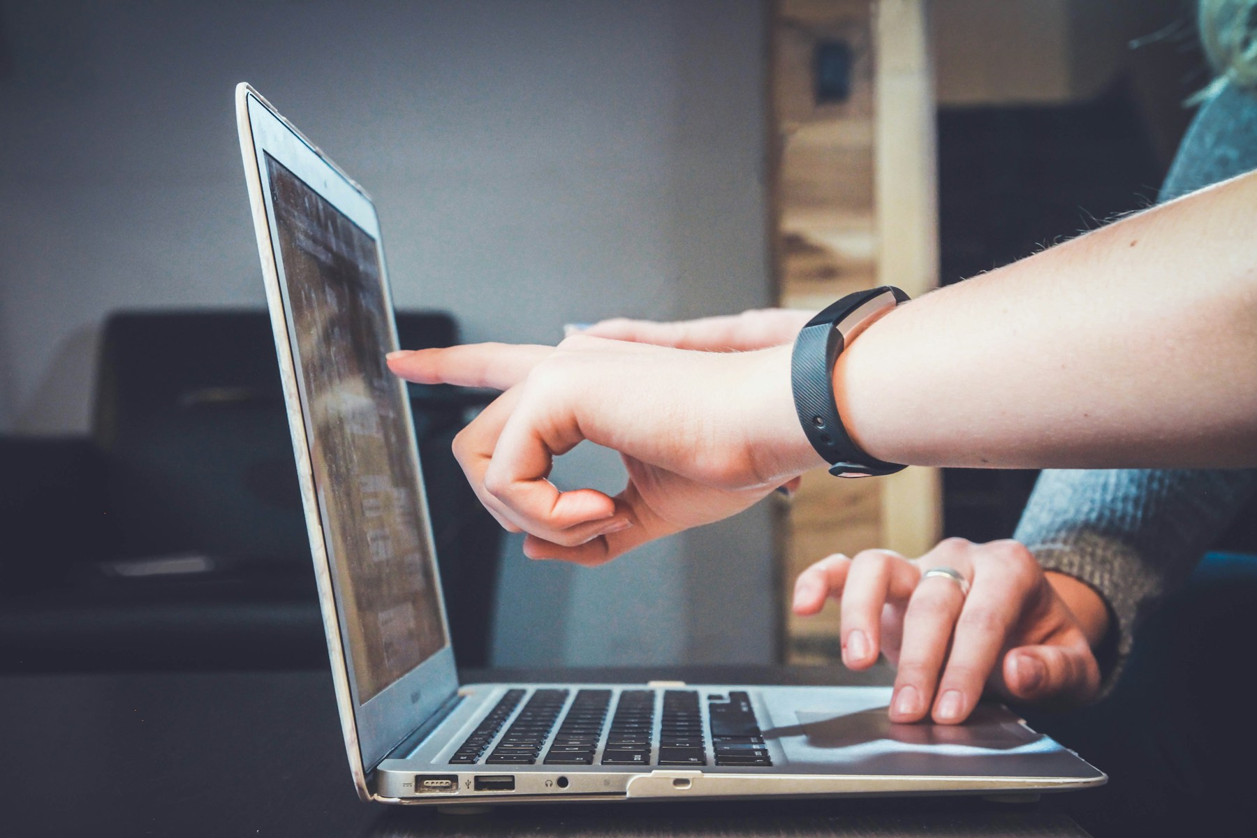 Two people working together on a laptop